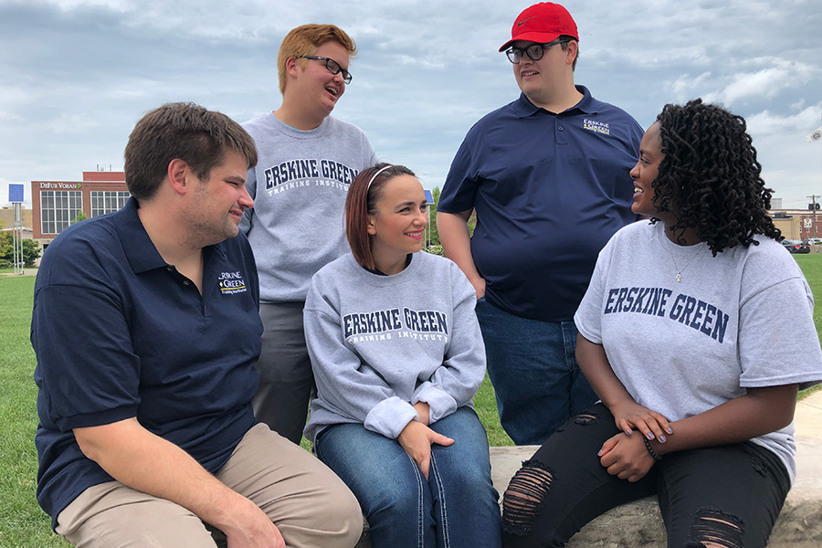 five students sitting and talking