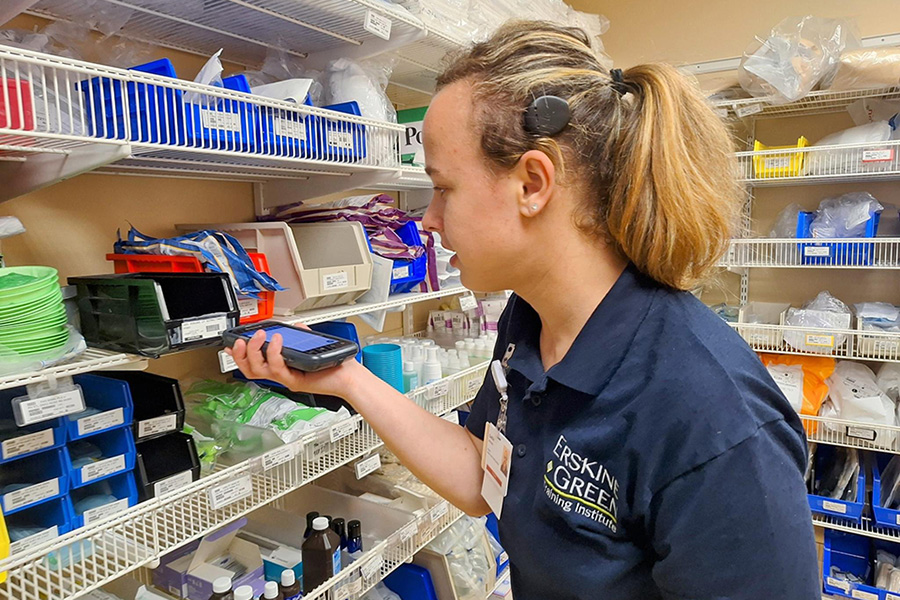 woman checking price of item on shelf